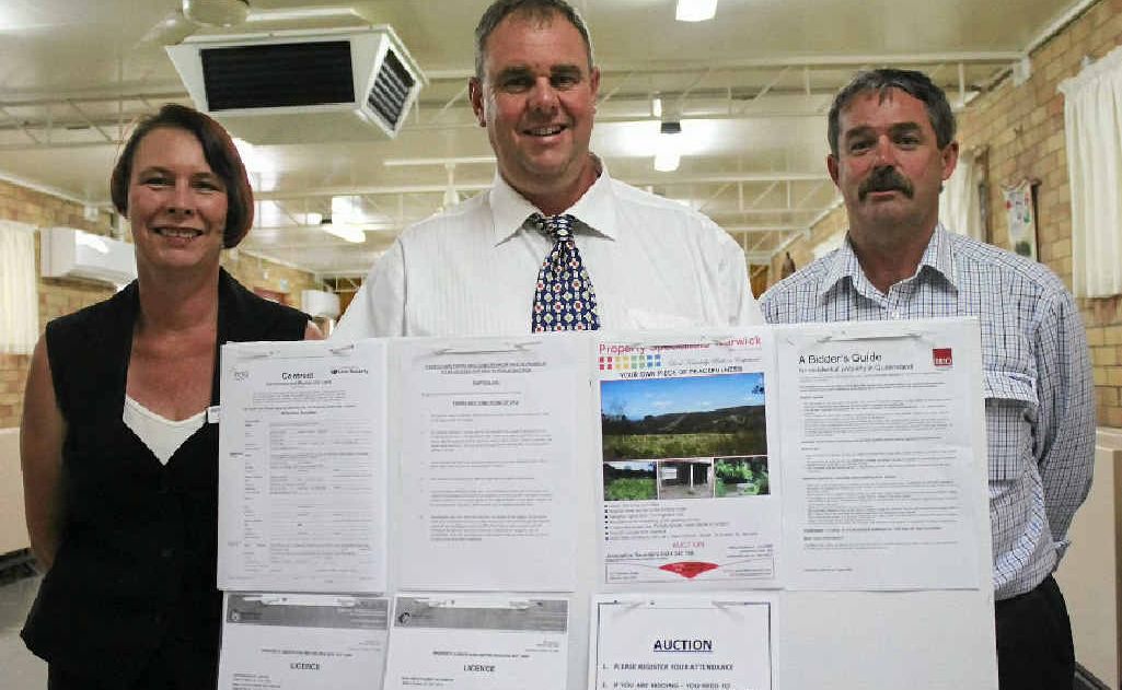 Property Specialists sales consultants Jacqueline Saunders and Brent Bowles with the highest bidder, Ray White Rural’s director and sales consultant Peter Lane. Property Specialists sales consultants Jacqueline Saunders and Brent Bowles with the highest bidder, Ray White Rural’s director and sales consultant Peter Lane.